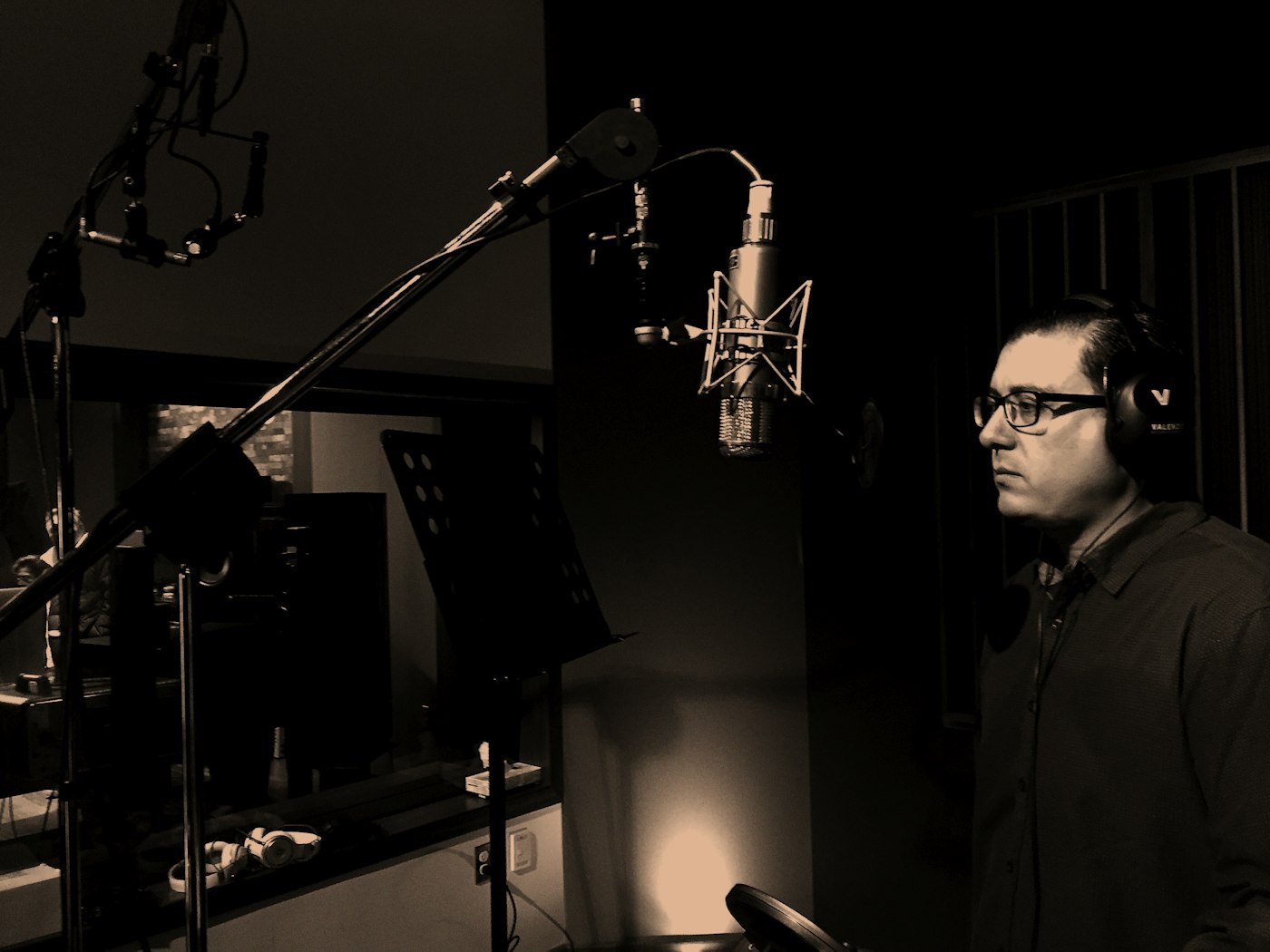 Artista en sesión de estudio con micrófono condenser, simbolizando una carrera musical impulsada con estrategia